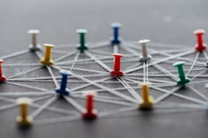 Colorful push pins connected with strings representing Stellar Career Accelerator's network of opportunities