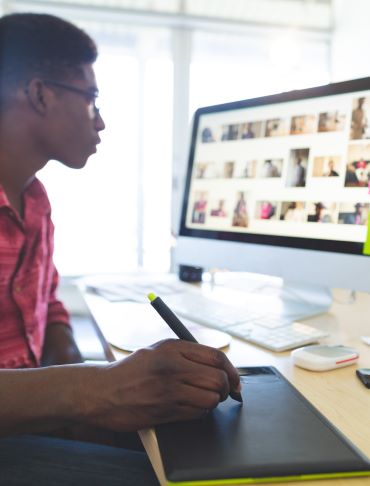 Graphic designer using a tablet and computer during Stellar Career Accelerator training