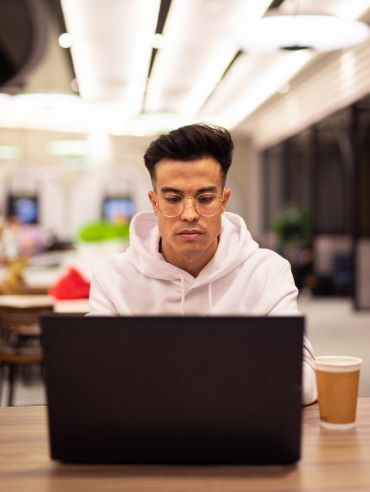 Young developer working on a laptop during Stellar Career Accelerator training